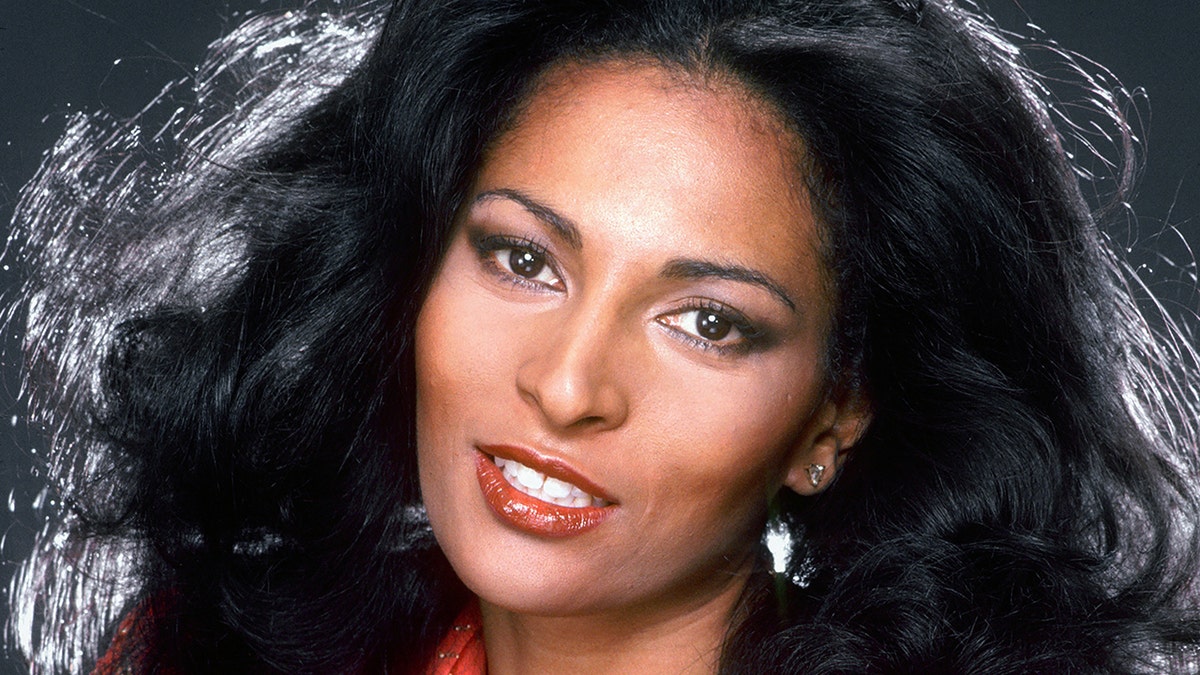 Pam Grier up close with red lipstick and blown out hair