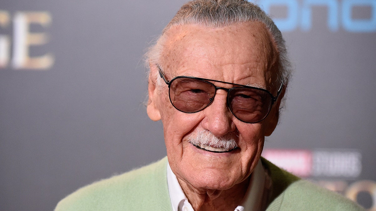 Stan Lee in his black shades and a light green sweater