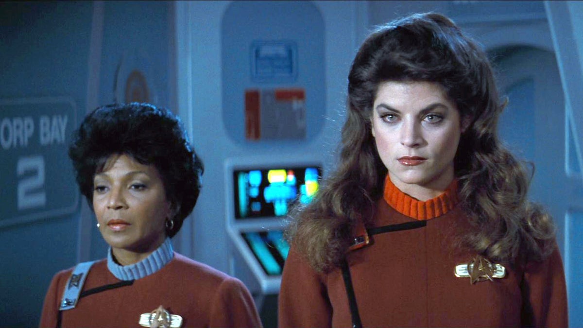 Nichelle Nichols in a blue collared red top and Kirstie Alley in a red collared red top in "Star Trek"