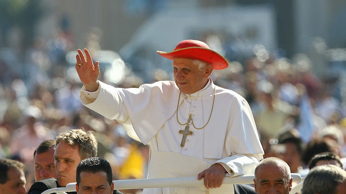 Pope Benedict in red hat waving