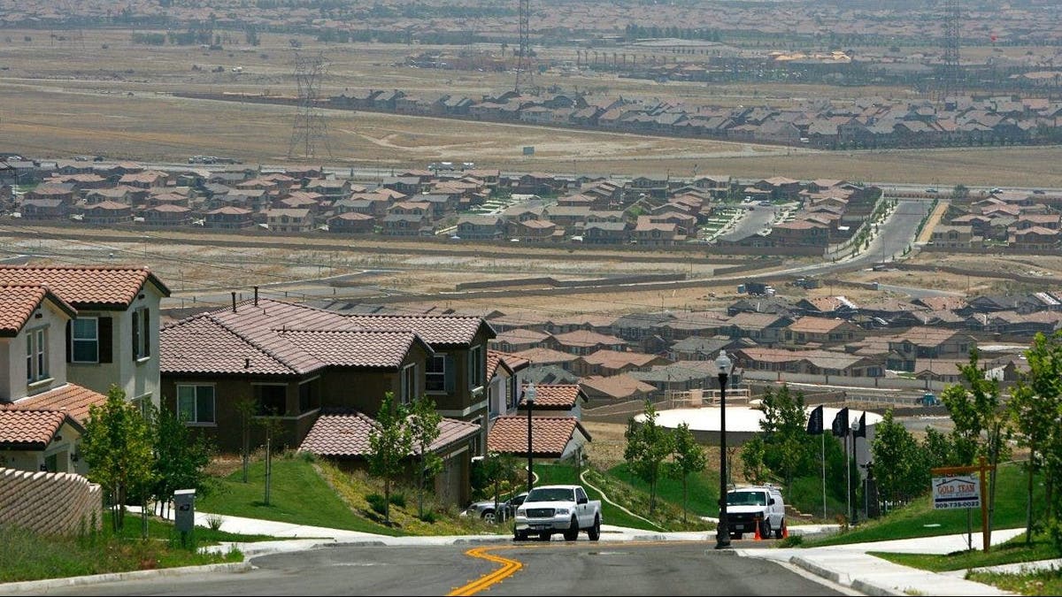 A gated community housing project overlooks a rural landscape that is being rapidly converted into a vast suburb as a construction boom continues in San Bernardino County, California.