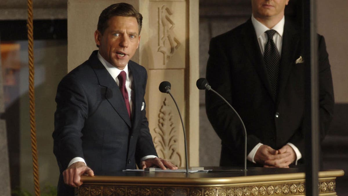 David Miscavige talks at a podium