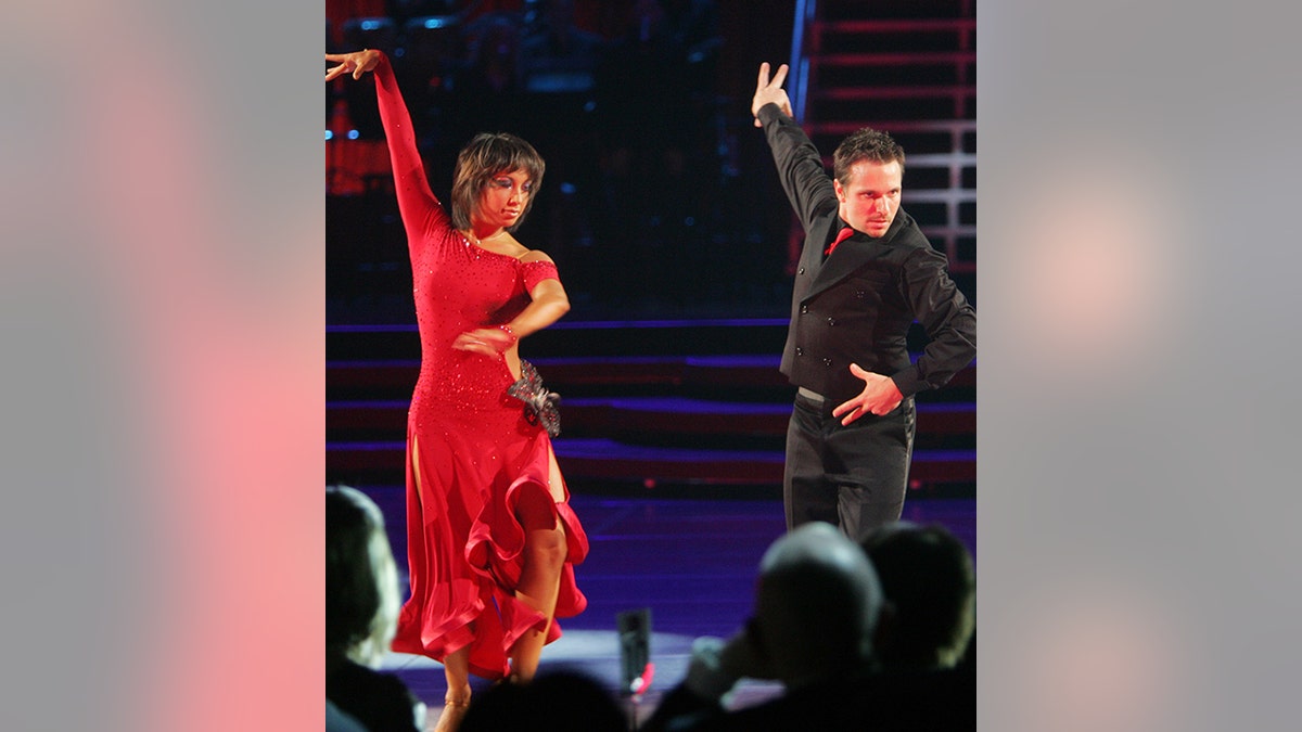 Cheryl Burke in a long red dress dances alongside her celebrity partner Drew Lachey on the second season of "Dancing with the Stars"