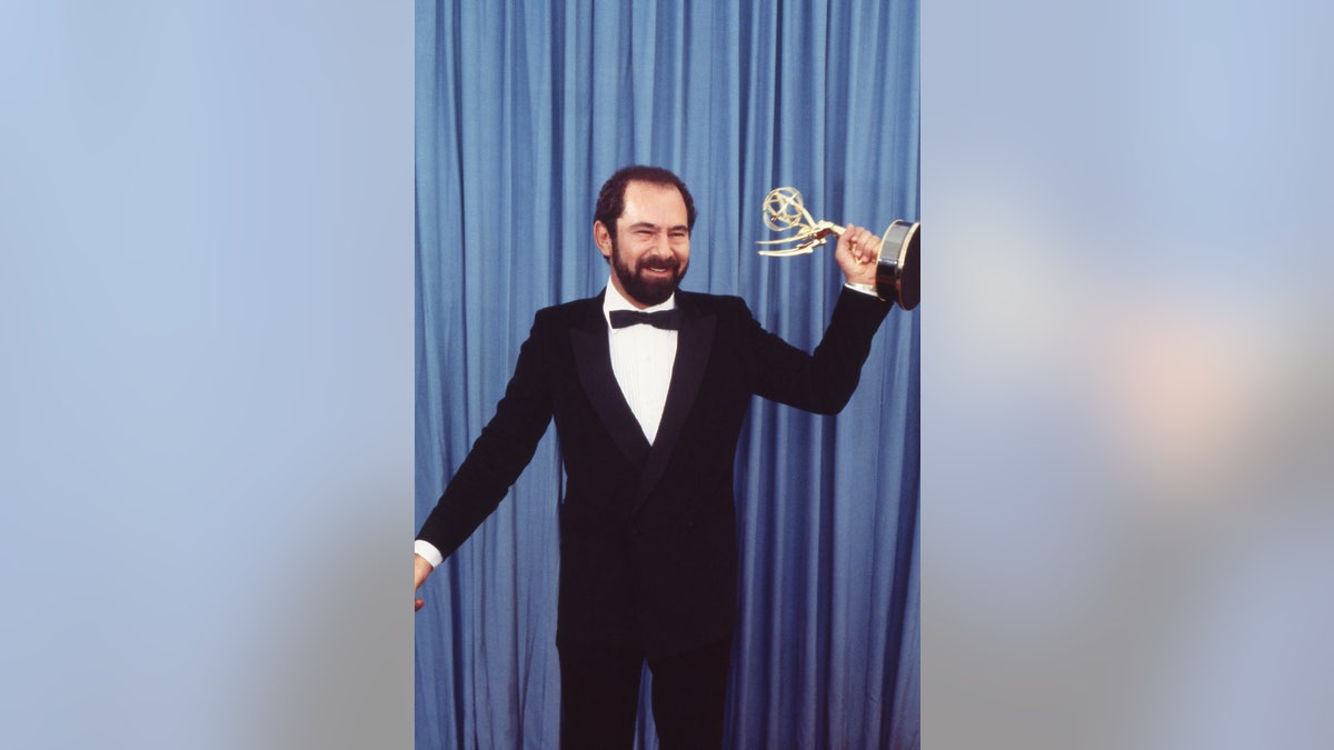 Stuart Margolin holding Emmy Award