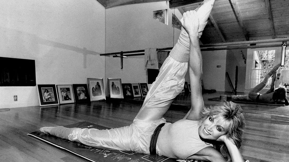 Donna Mills stretching at her home gym