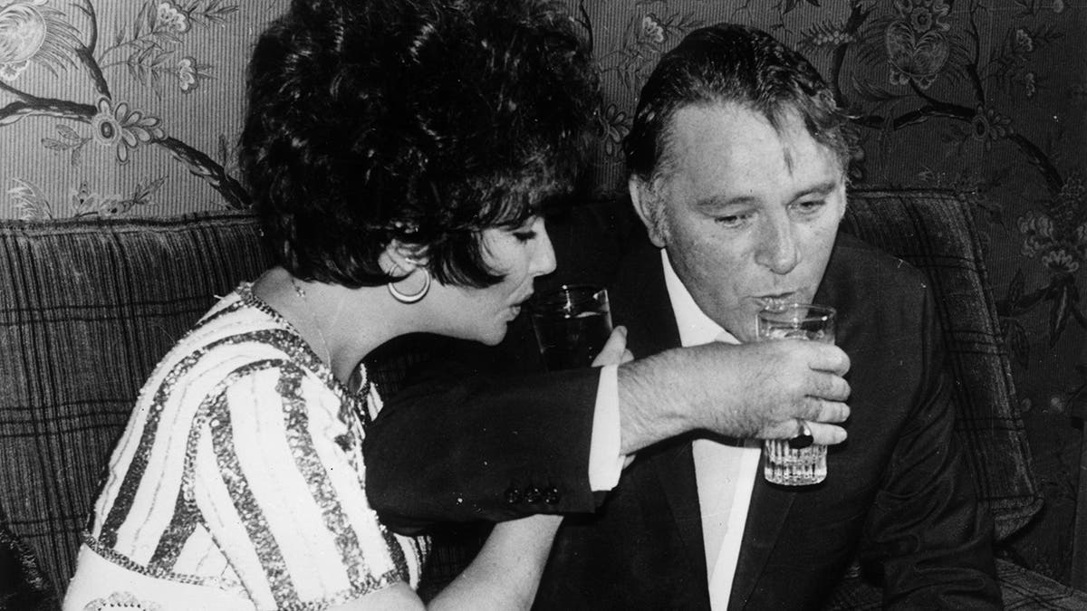 Richard Burton and Elizabeth Taylor drinking