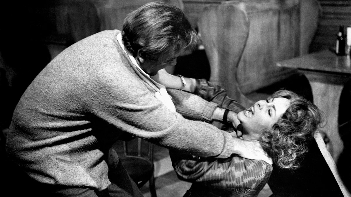 Elizabeth Taylor and Richard Burton fighting in a movie scene