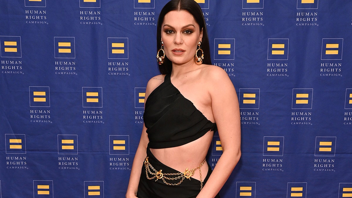 Jessie J on the red carpet in a black dress with side cut out
