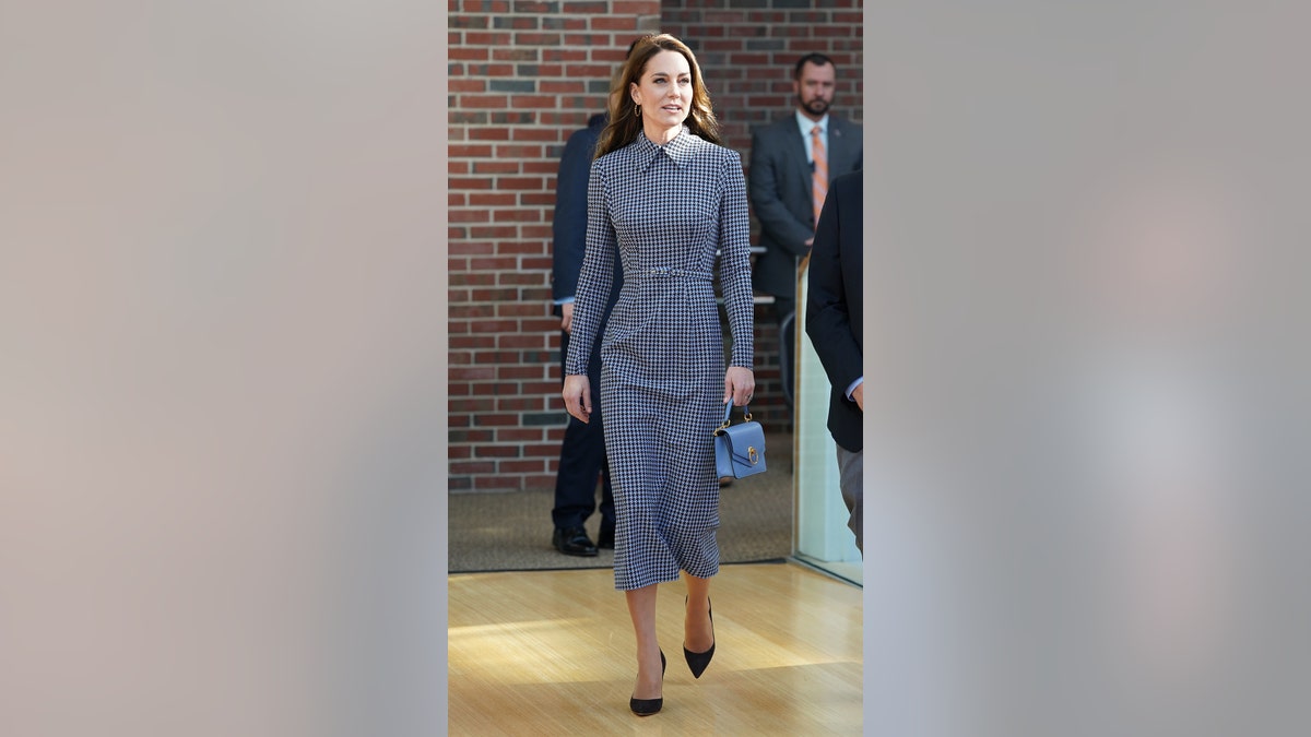 Kate Middleton holding her purse while visiting Harvard University