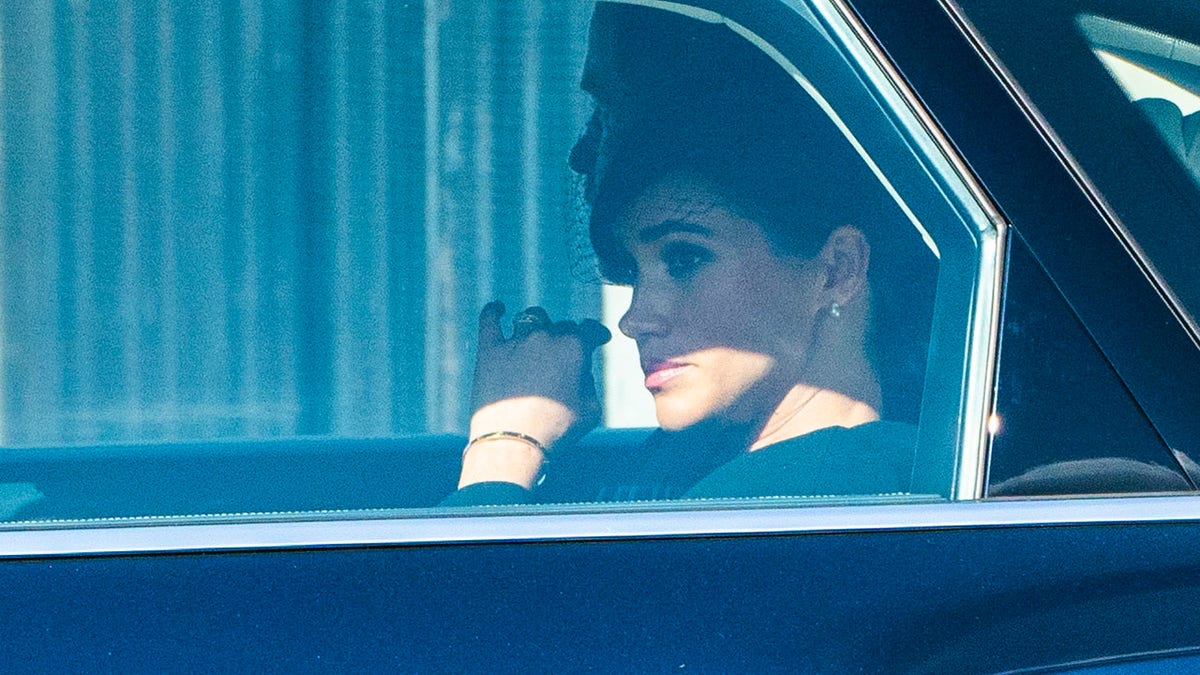 Meghan Markle in a car looking somber