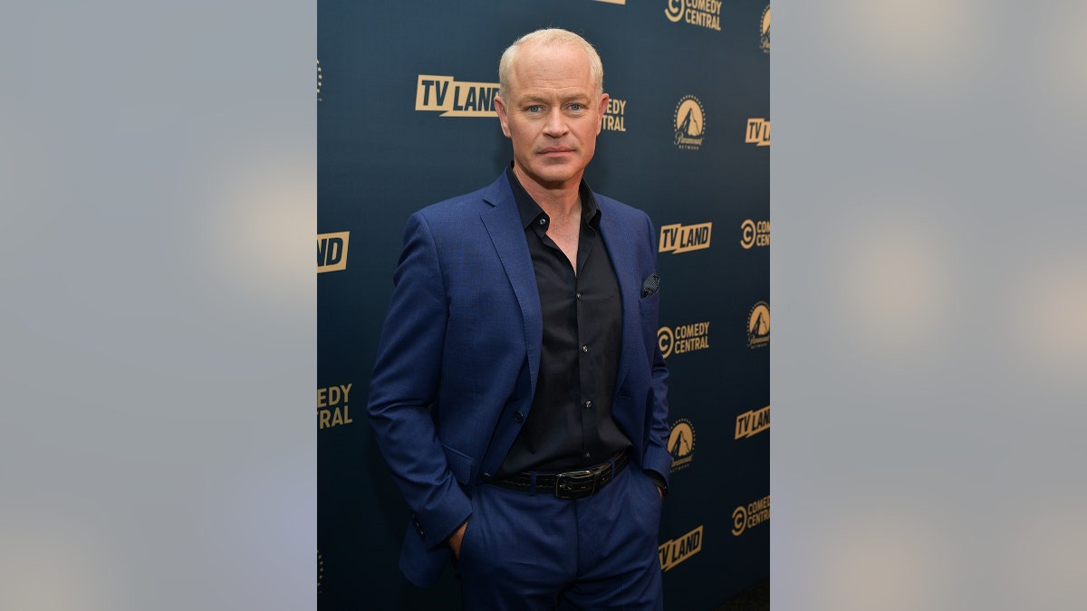Neal McDonough looking serious in blue