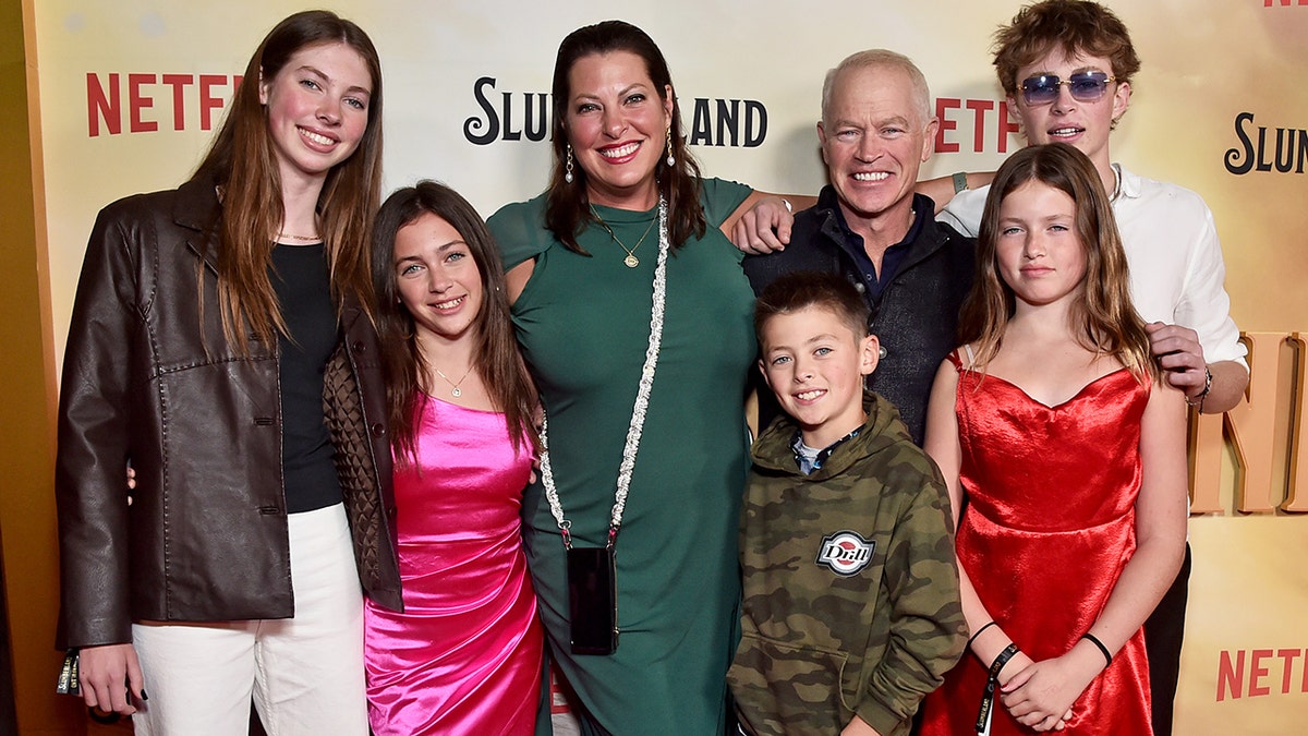 Neal McDonough smiling with his family