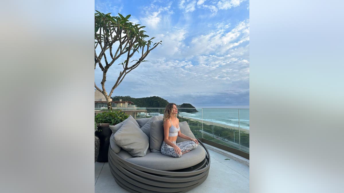 Gisele Bündchen meditates on a gray chair while on vacation in Brazil