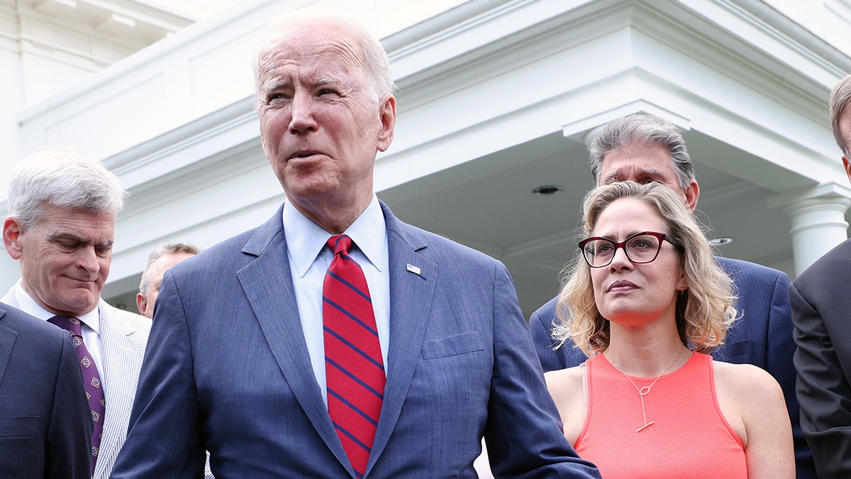 President Biden seen with Kyrsten Sinema