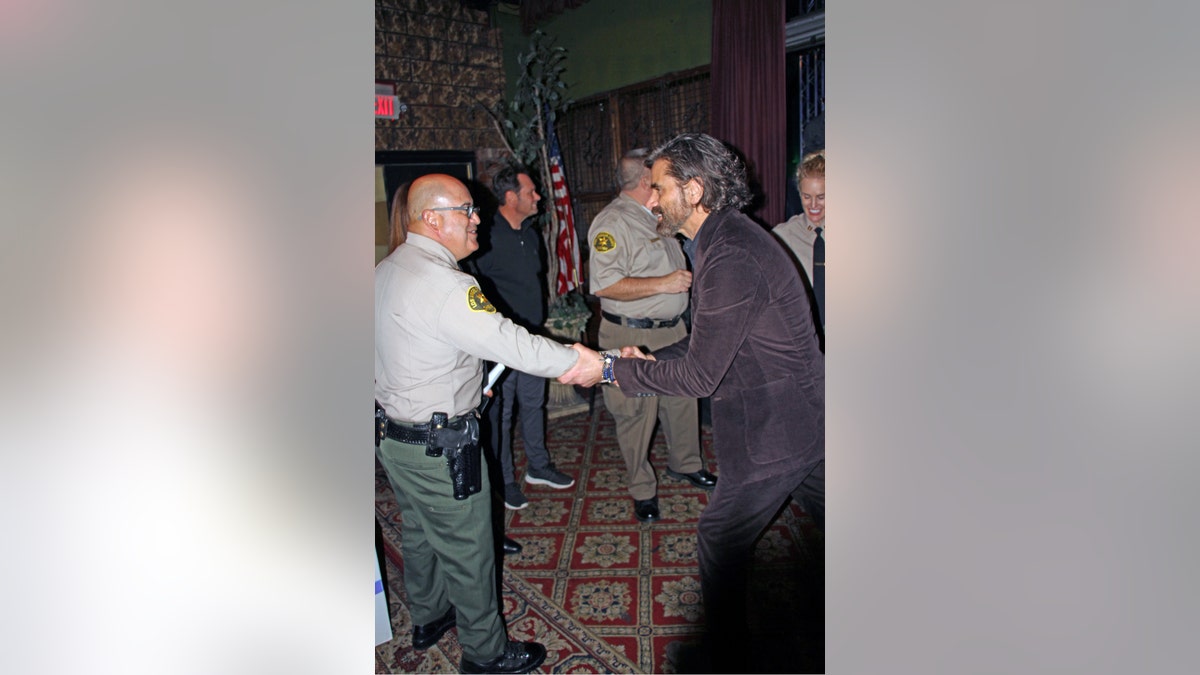 John Stamos with sheriffs department officials
