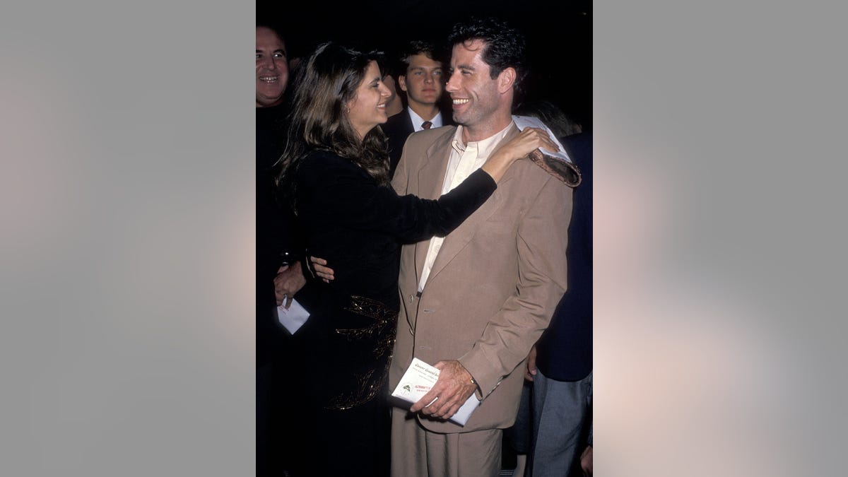John Travolta and Kirstie Alley embrace at premiere