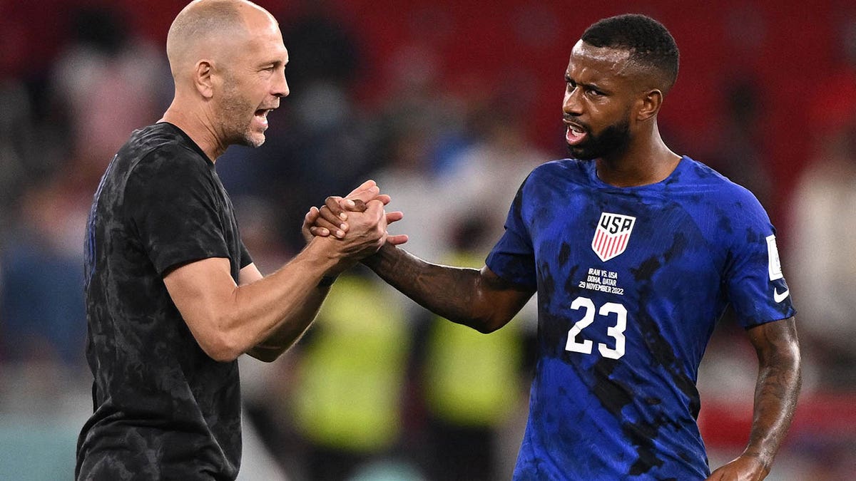 Gregg Berhalter with team member