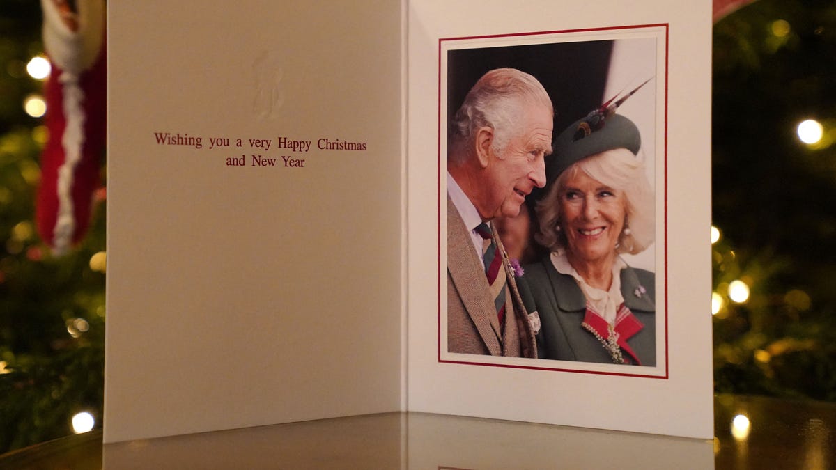 King Charles III looks at wife Queen Consort Camilla in holiday card by Christmas tree