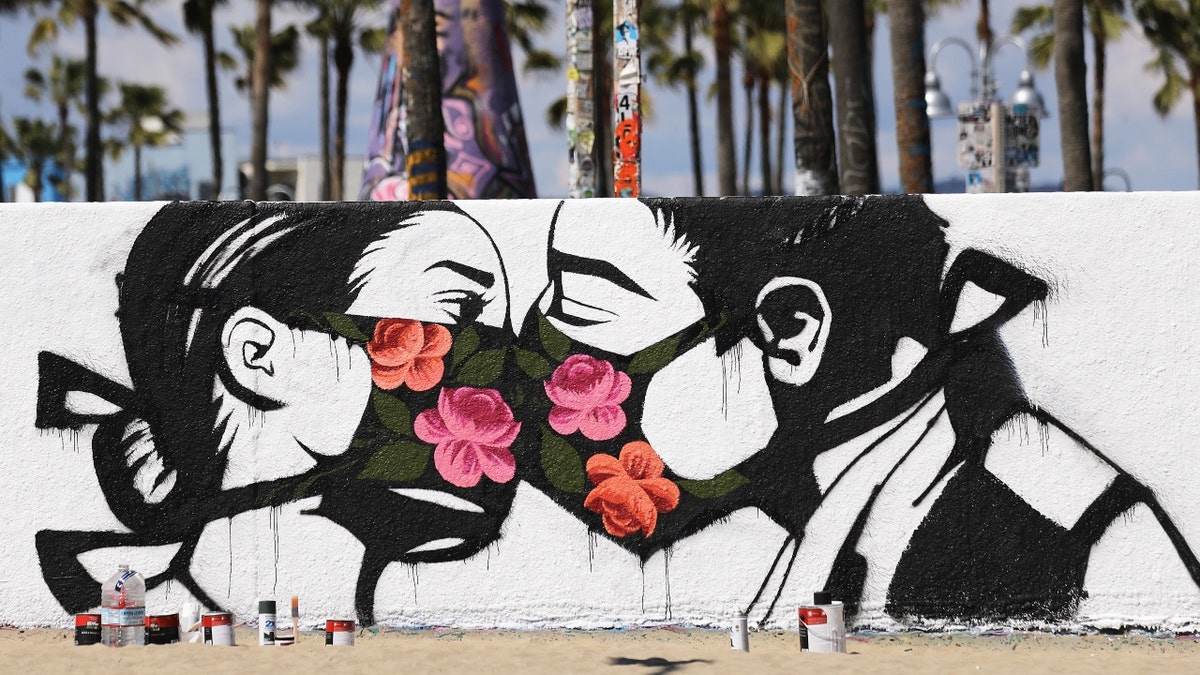 Art showing a couple kissing wearing masks