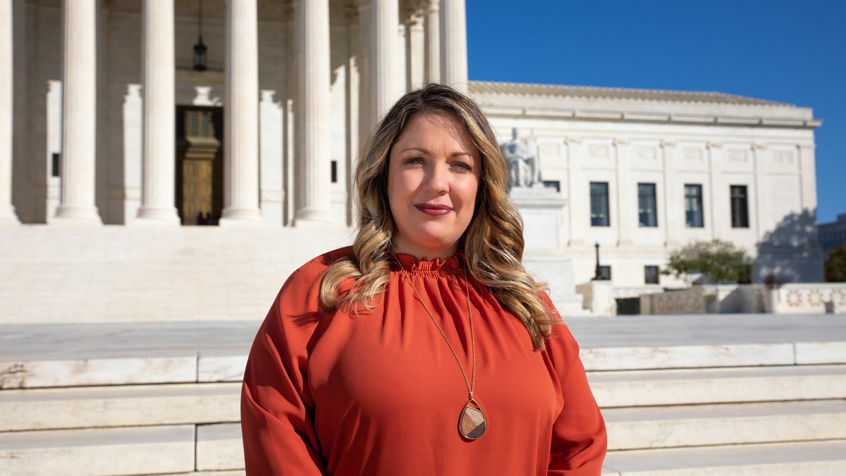 303 Creative owner Lorie Smith stands in front of the Supreme Court.