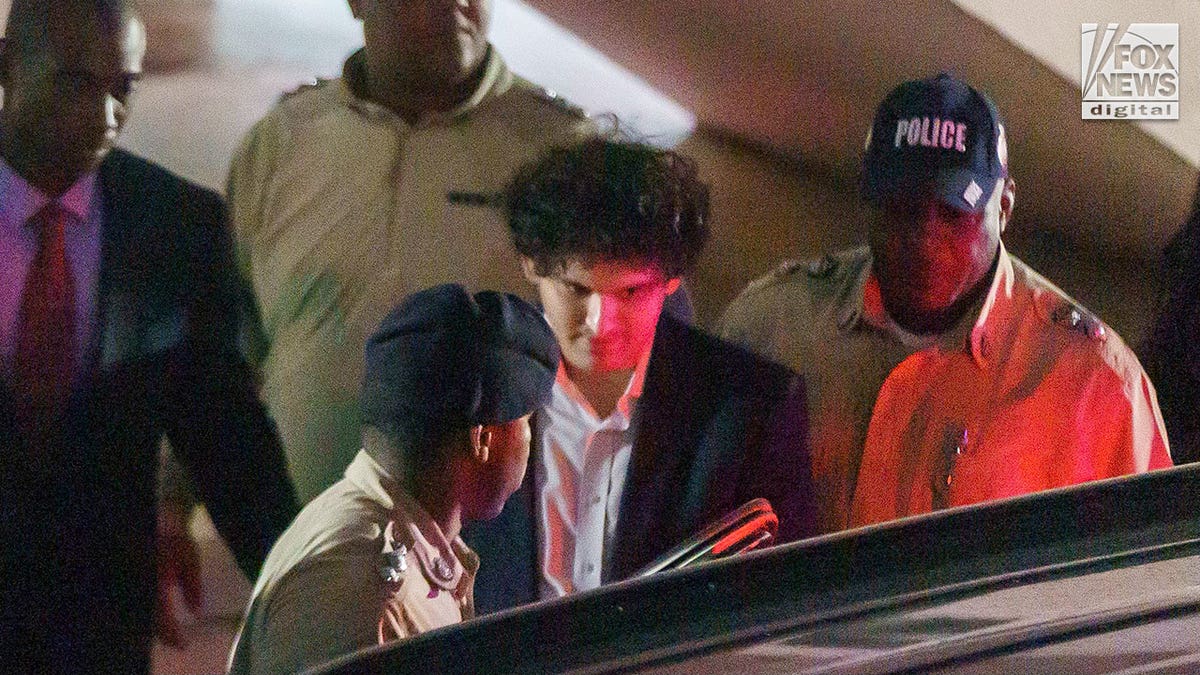 SBF being led to car