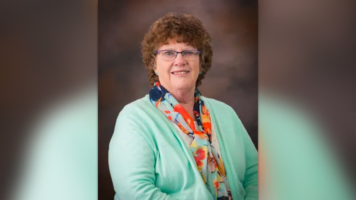 Cathy Mabbutt, Latah County Coroner poses in a green sweater