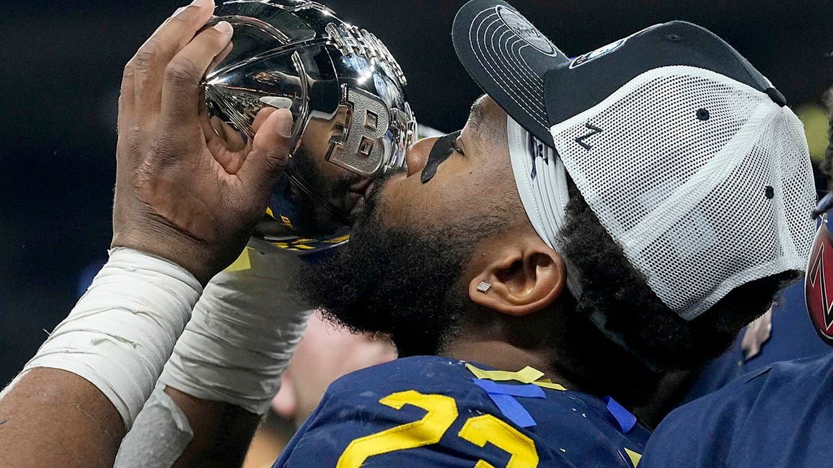 Michael Barrett kisses the trophy