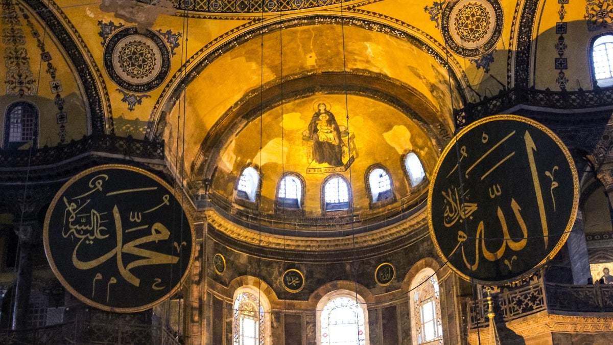 Muhammad calligraphy with Christian mural in Hagia Sophia