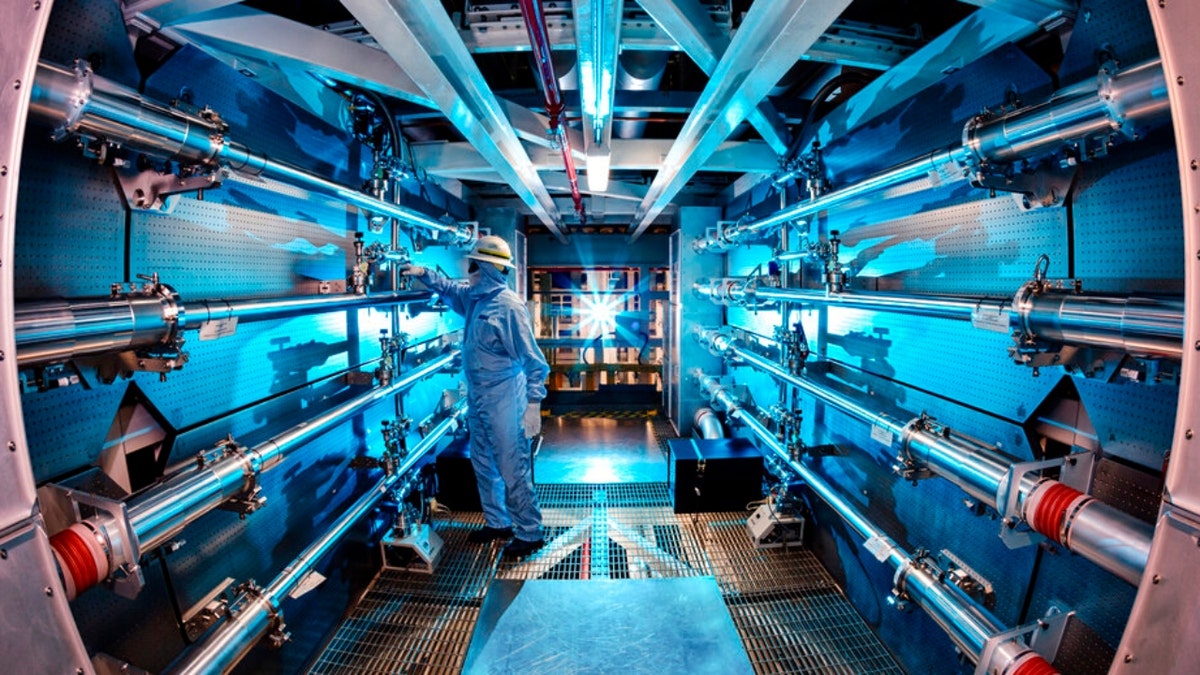 A technician reviews an optic inside the preamplifier support structure at the Lawrence Livermore National Laboratory