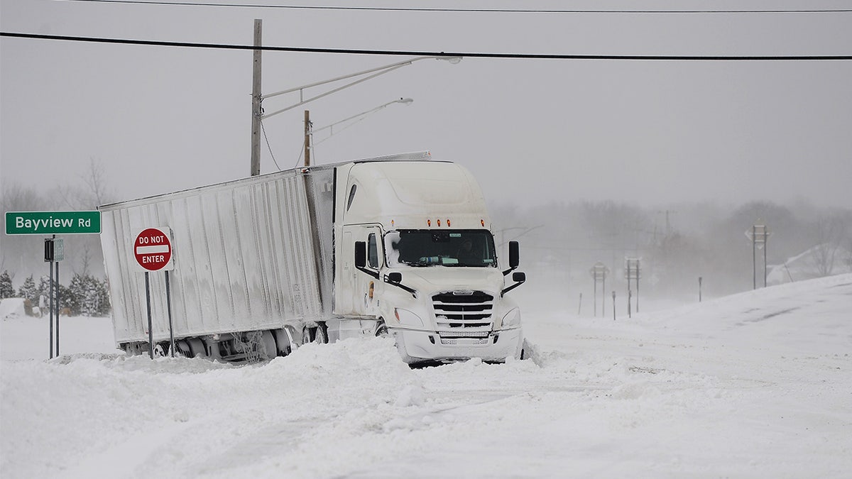 Truck driving through snow