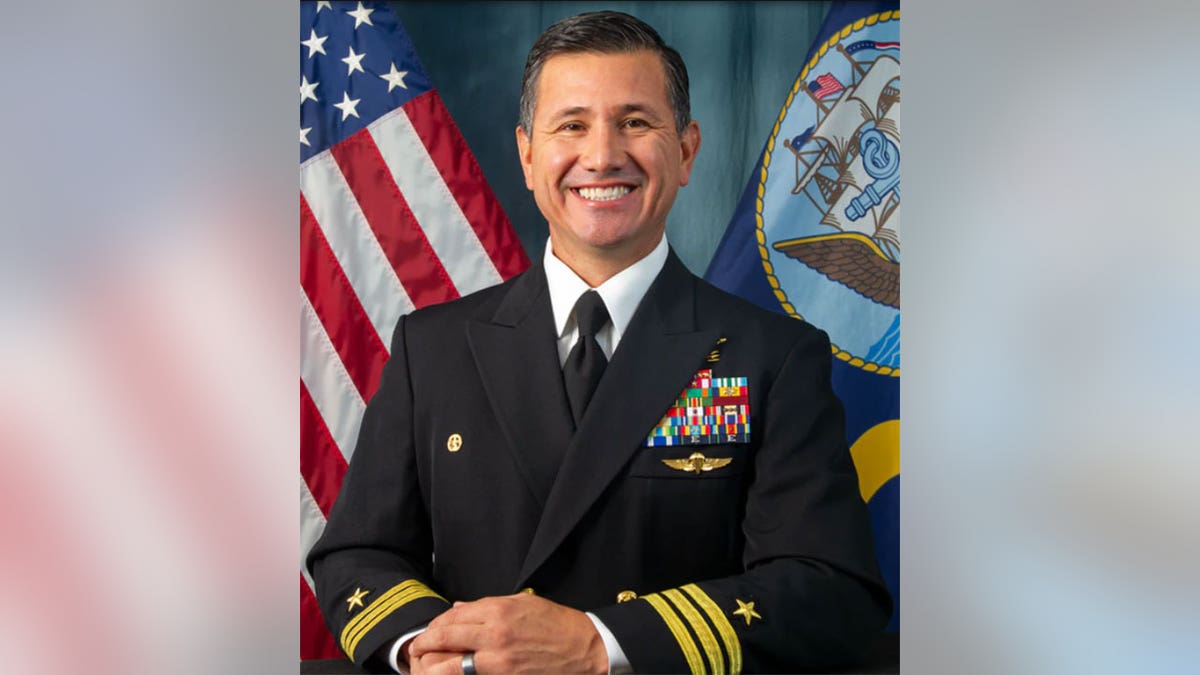 Robert Ramirez smiles in decorated Navy uniform