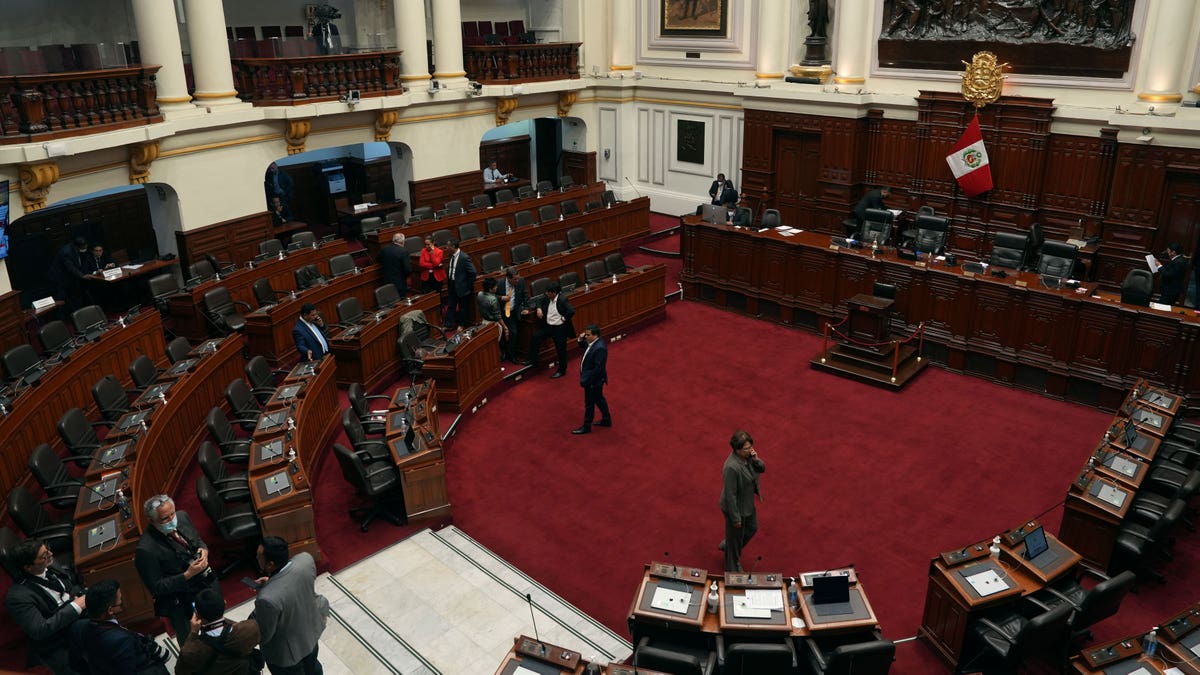 Legislators standing in the Peruvian Congress