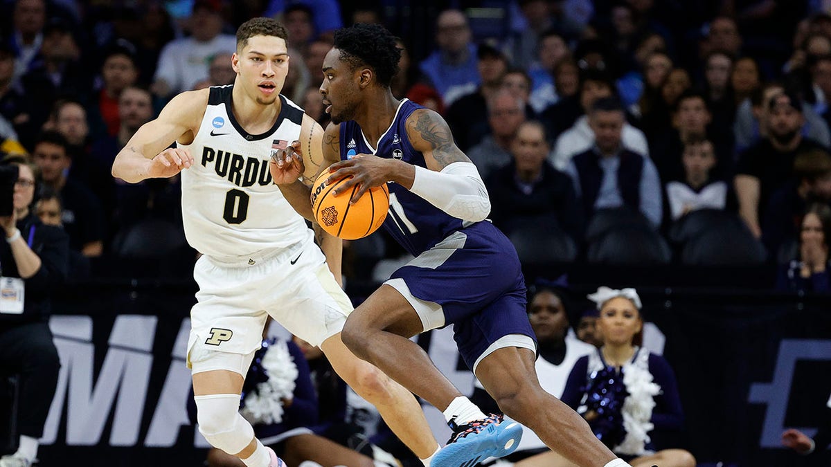 KC Ndefo dribbles for Saint Peter's basketball team