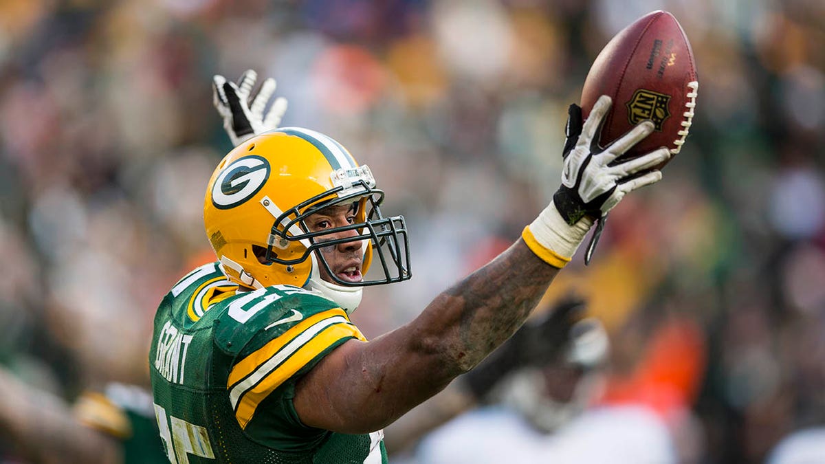 Green Bay Packers running back Ryan Grant (L) and receiver Donald Driver  celebrate Grant's 47-yard touchdown run against the Oakland Raiders during  the first quarter at Lambeau Field on December 11, 2011