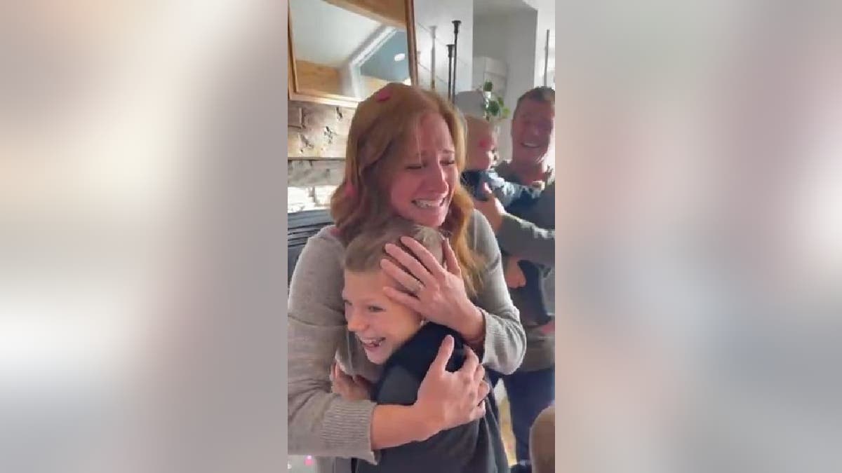 Sarah Molitor hugs her son