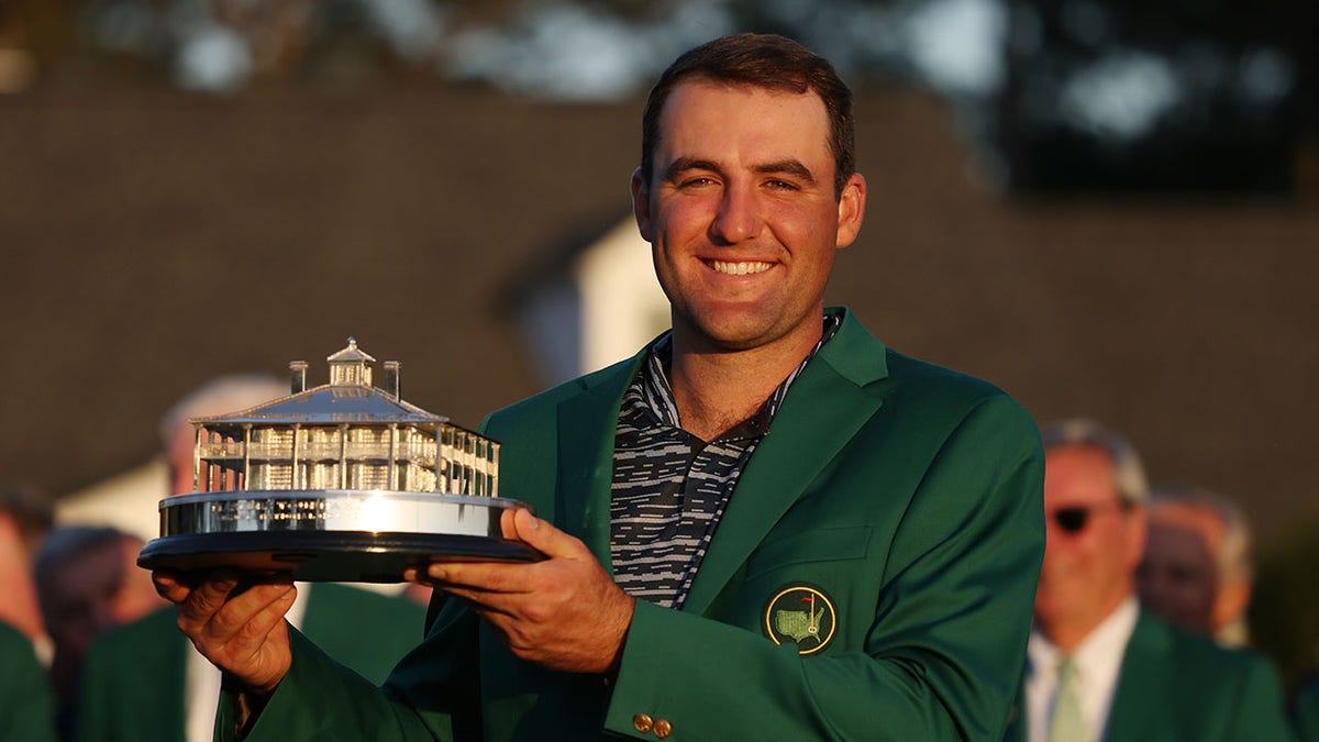 Scottie Scheffler poses with the Masters trophy