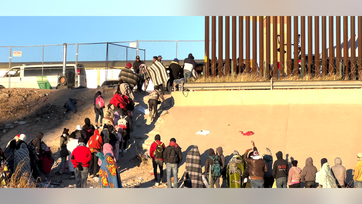 Migrants standing in line at the Border