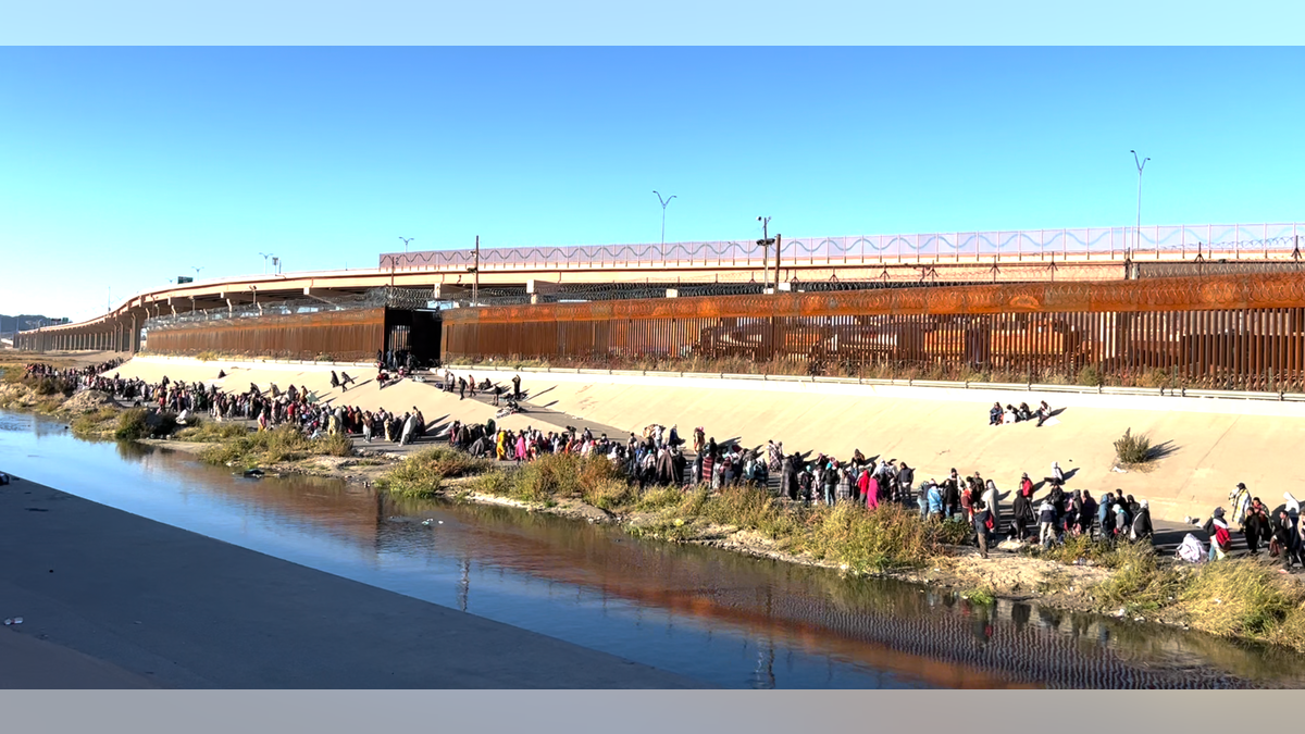 Migrants in line by the Rio Grande