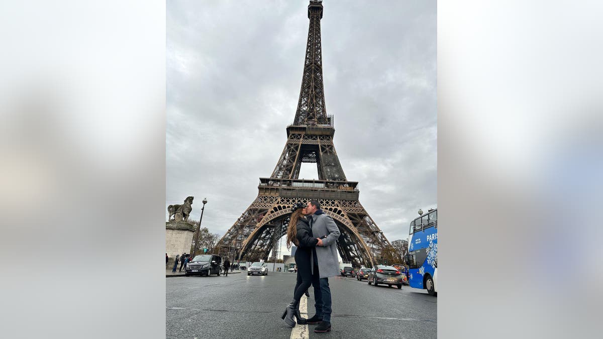 Teresa Giudice and husband Luis Ruelas share a sweet kiss in front of the Eiffel Tower