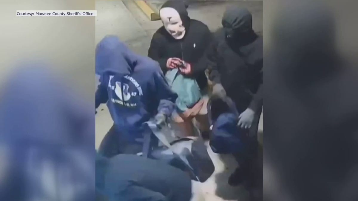 Masked people breaking into shop