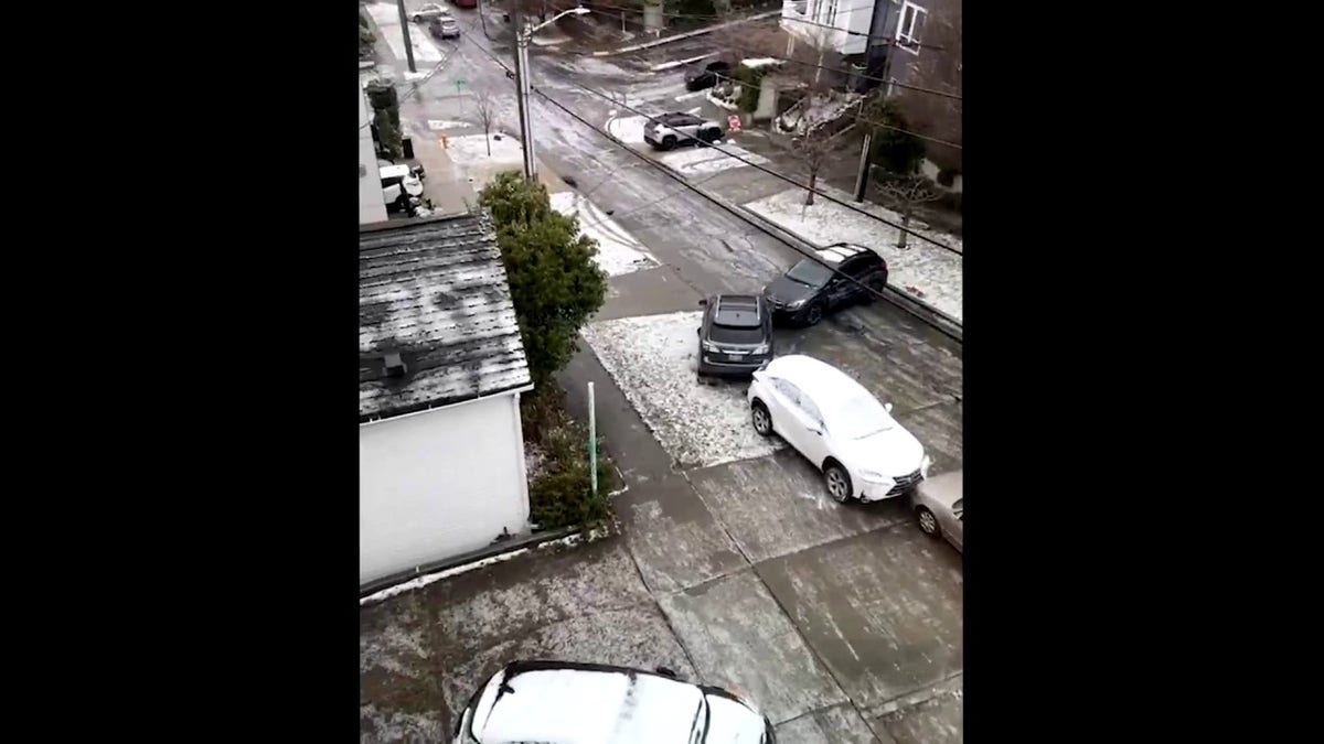 Seattle winter weather creates dangerous driving conditions, video shows car sliding down street