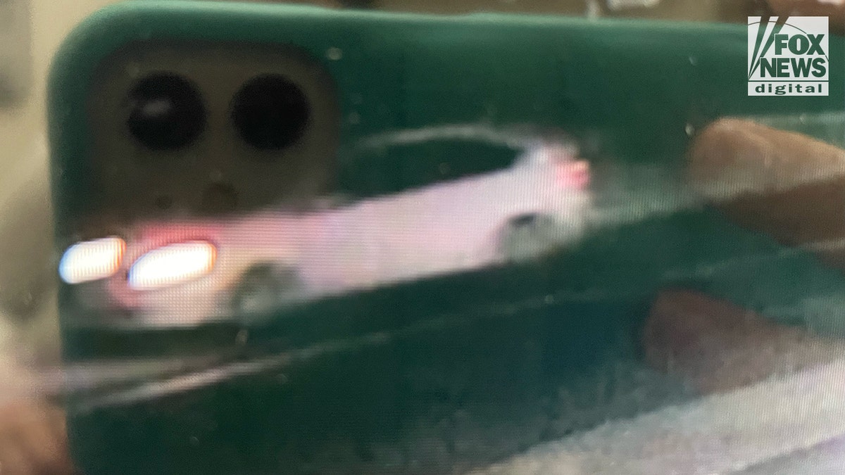 White car moving fast in blurry still from video