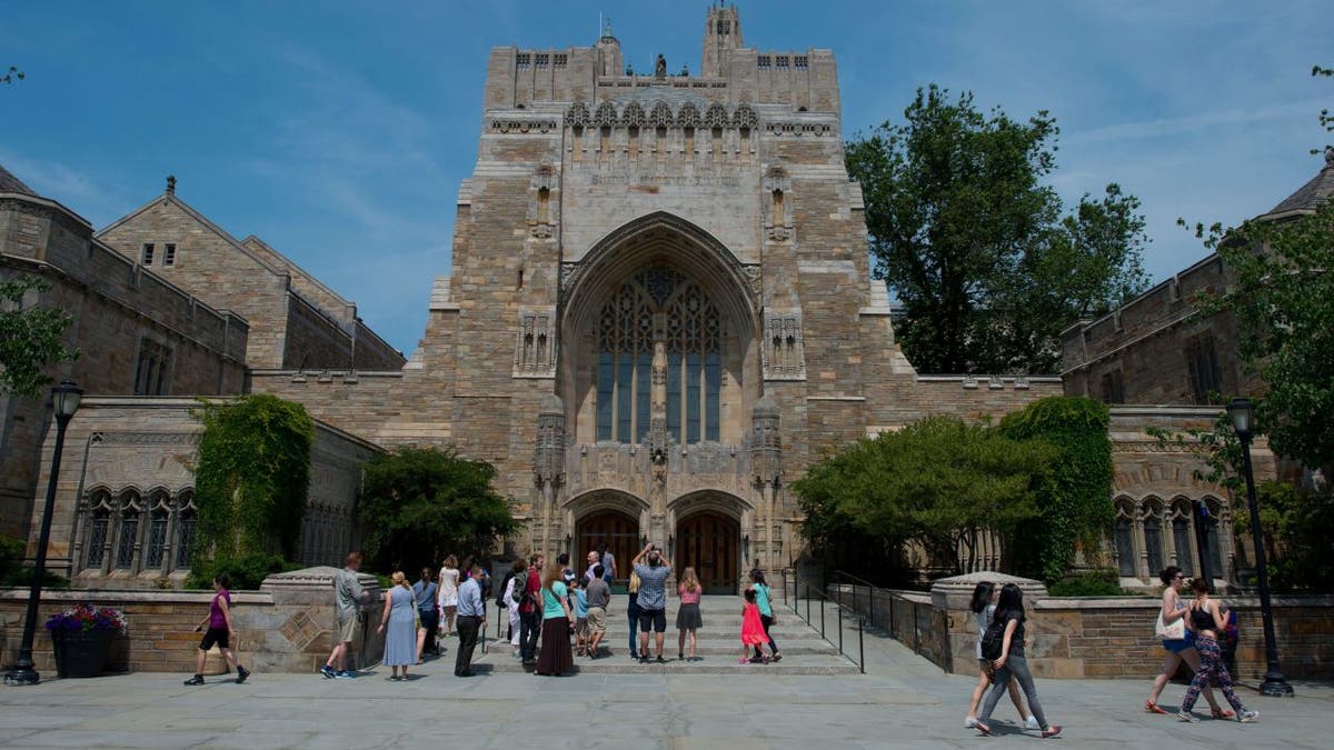 A tour group makes a stop at the Sterling Memorial Library on the Yale University campus in New Haven, Conn., June 12, 2015.