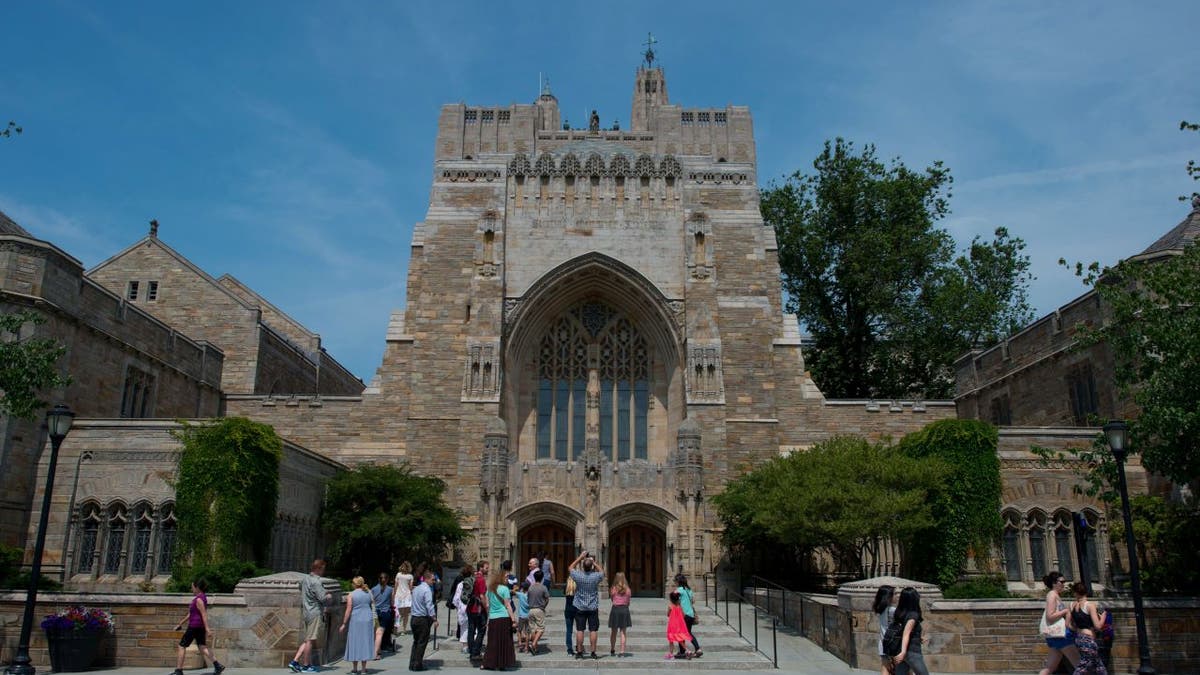 A tour group makes a stop at the Sterling Memorial Library on the Yale University campus in New Haven, Conn., June 12, 2015.