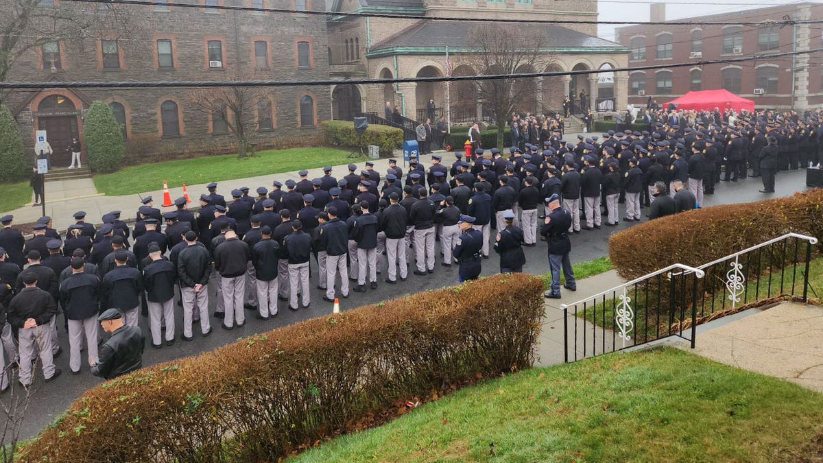 Policemen stand four rows deep outside the church