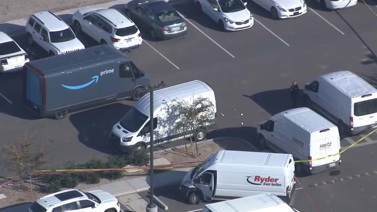 Amazon parking lot in Arizona with police tape, aerial view