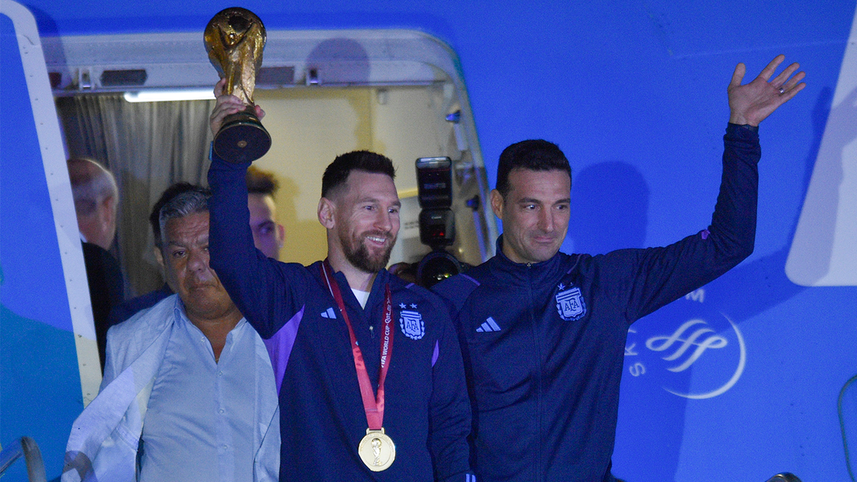 Lionel Messi holds the FIFA World Cup trophy