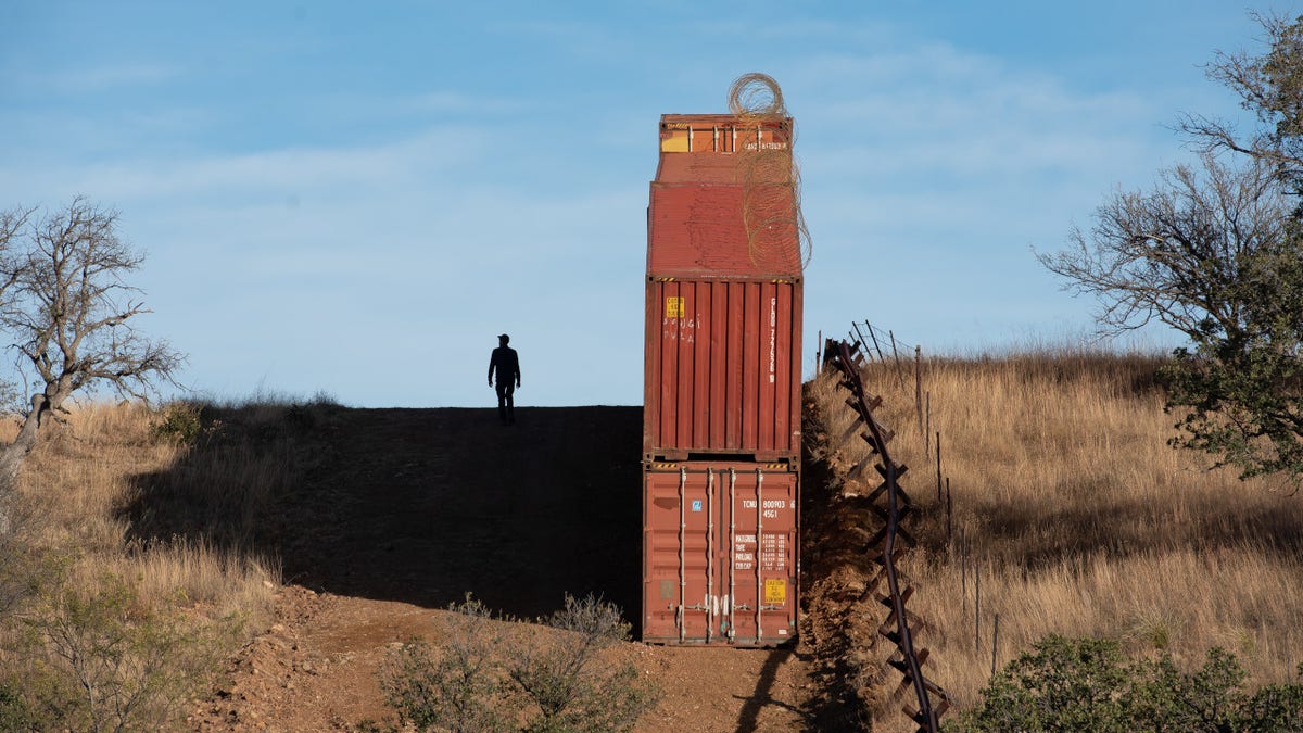 Shipping containers and vehicle barriers line the US and Mexico Border at Coronado National Memorial in Cochise County, Arizona