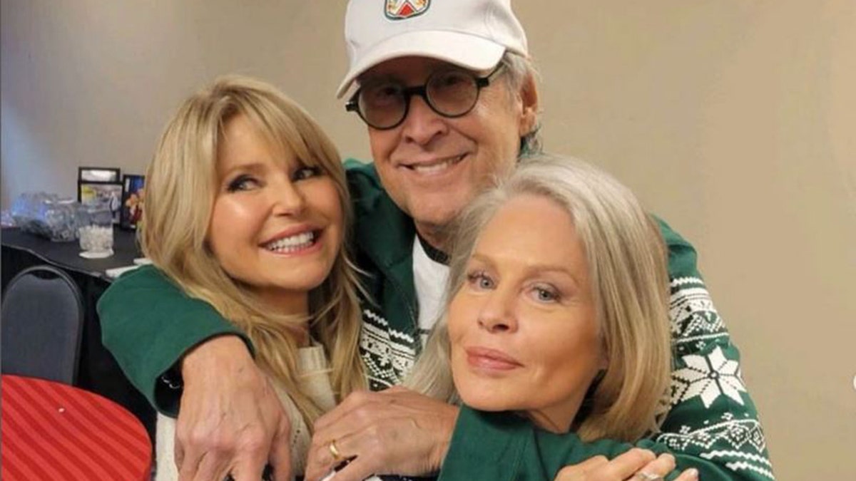 Chevy Chase hugs Christie Brinkley and Beverly D'Angelo