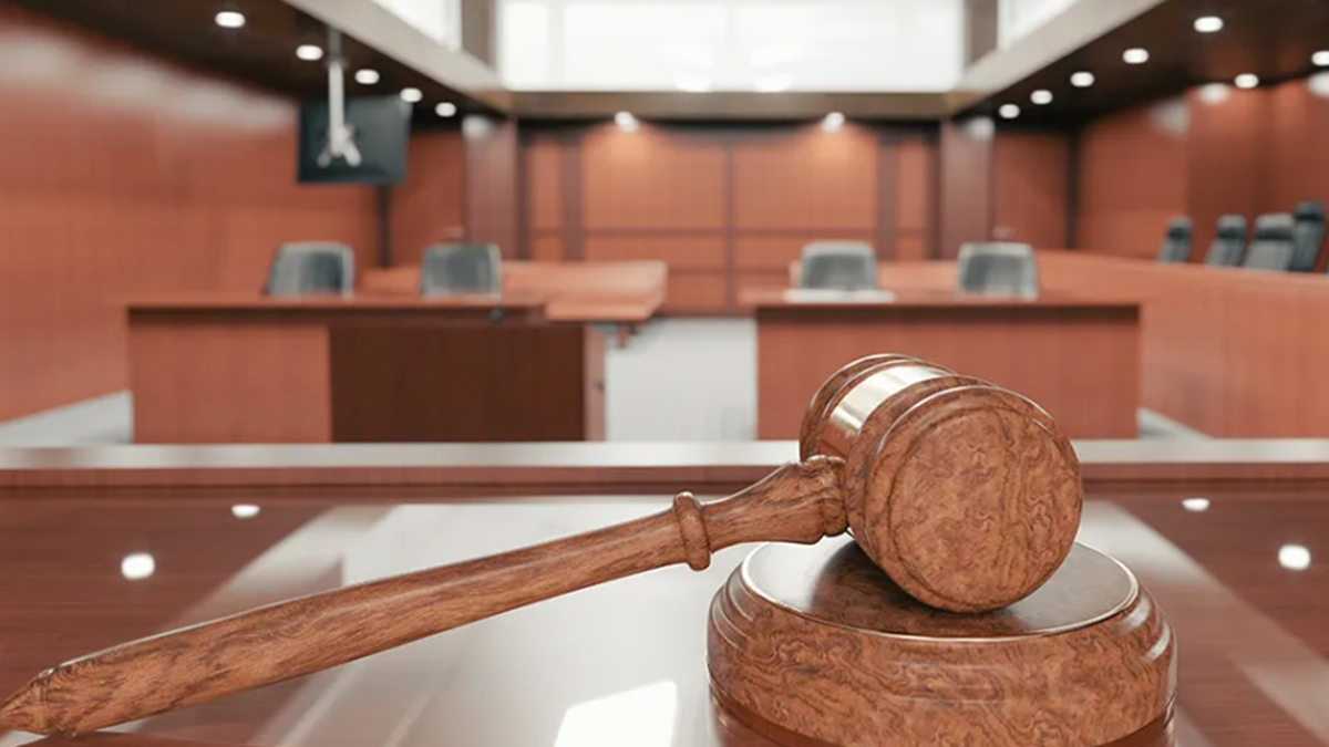 gavel on court bench in empty courtroom stock photo